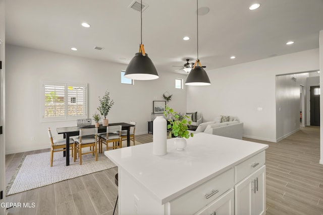 14932 Hill Ridge Ct, El Paso, TX 79938 - kitchen featuring light wood-style flooring, baseboards, recessed lighting, white cabinets, and light countertops