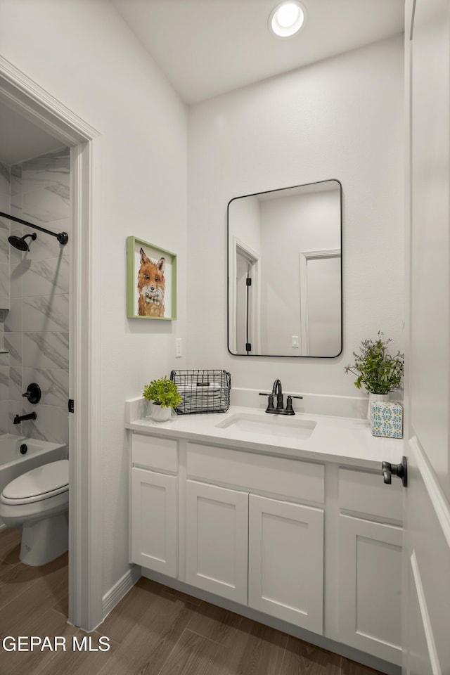 14932 Hill Ridge Ct, El Paso, TX 79938 - bathroom with vanity, toilet, wood finished floors, shower / tub combination, and recessed lighting