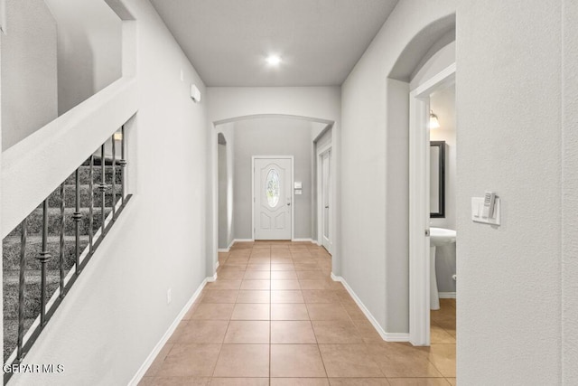 14270 Don Johnson, El Paso, TX 79938 - foyer featuring arched walkways, light tile patterned flooring, stairway, and baseboards
