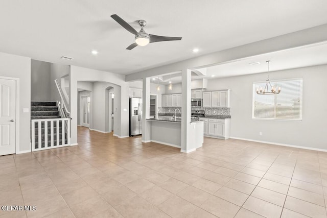 14270 Don Johnson, El Paso, TX 79938 - unfurnished living room featuring a ceiling fan, light tile patterned floors, a chandelier, recessed lighting, and stairs