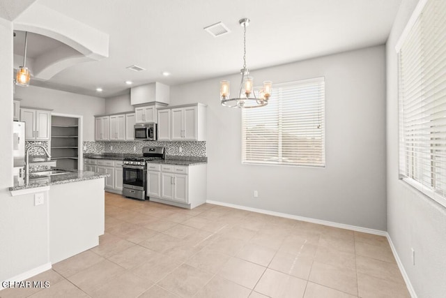 14270 Don Johnson, El Paso, TX 79938 - kitchen with appliances with stainless steel finishes, a sink, tasteful backsplash, a chandelier, and dark stone countertops