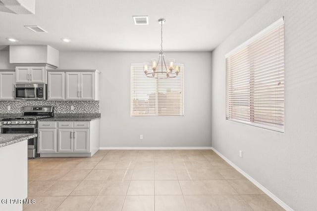 14270 Don Johnson, El Paso, TX 79938 - kitchen featuring stainless steel appliances, a chandelier, backsplash, light tile patterned flooring, and hanging light fixtures