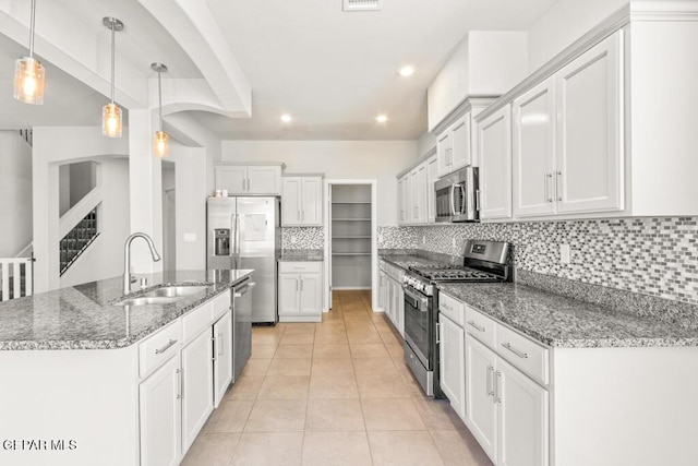 14270 Don Johnson, El Paso, TX 79938 - kitchen featuring stainless steel appliances, a sink, backsplash, white cabinetry, and recessed lighting