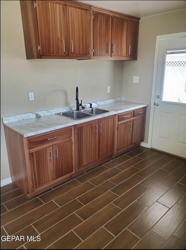 4943 Aiken Ln, El Paso, TX 79924 - kitchen featuring a sink, light countertops, brown cabinets, and wood finish floors