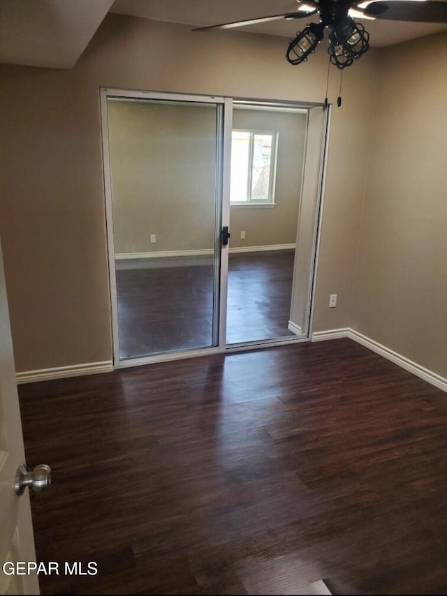 4943 Aiken Ln, El Paso, TX 79924 - unfurnished bedroom featuring baseboards, wood finished floors, a closet, and a ceiling fan