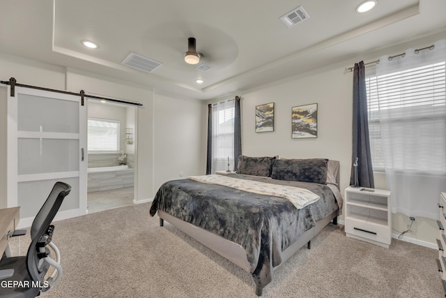 281 Farnborough St, Horizon City, TX 79928 - bedroom with a tray ceiling, carpet floors, a barn door, multiple windows, and recessed lighting