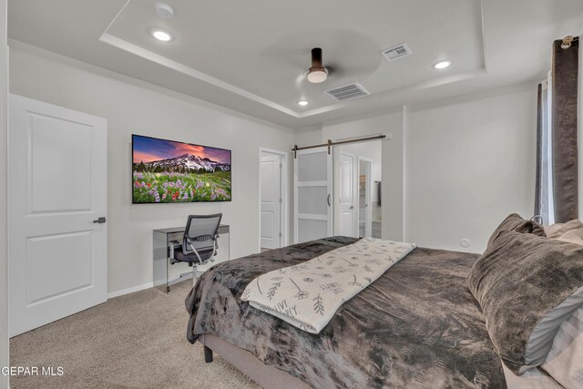 281 Farnborough St, Horizon City, TX 79928 - bedroom with a tray ceiling, recessed lighting, light colored carpet, a barn door, and baseboards