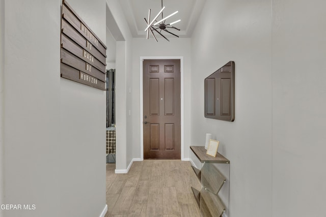 281 Farnborough St, Horizon City, TX 79928 - doorway to outside with light wood-style flooring, a chandelier, and baseboards