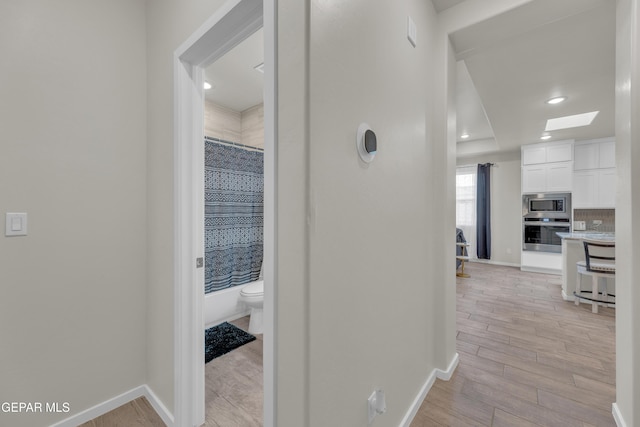 281 Farnborough St, Horizon City, TX 79928 - hall with baseboards, a skylight, light wood finished floors, and recessed lighting