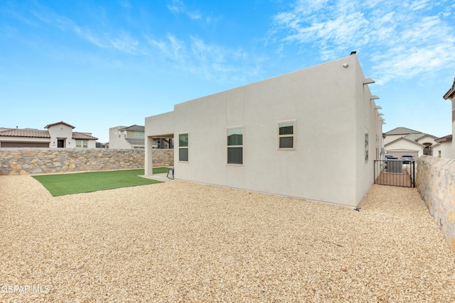 281 Farnborough St, Horizon City, TX 79928 - rear view of house featuring a fenced backyard, stucco siding, and a gate