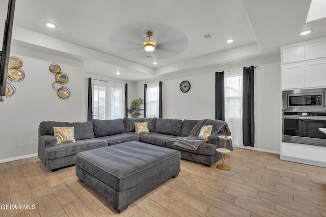 281 Farnborough St, Horizon City, TX 79928 - living room featuring a raised ceiling, ceiling fan, light wood finished floors, baseboards, and recessed lighting