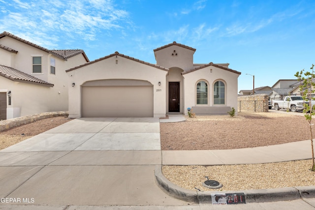 281 Farnborough St, Horizon City, TX 79928 - mediterranean / spanish house featuring driveway, an attached garage, stucco siding, and a tiled roof