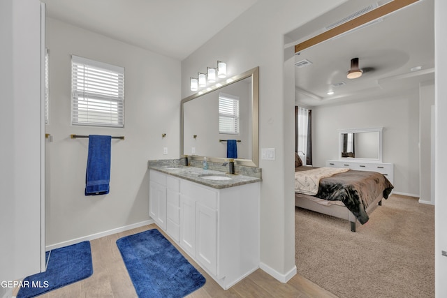 281 Farnborough St, Horizon City, TX 79928 - ensuite bathroom featuring double vanity, wood finished floors, and baseboards