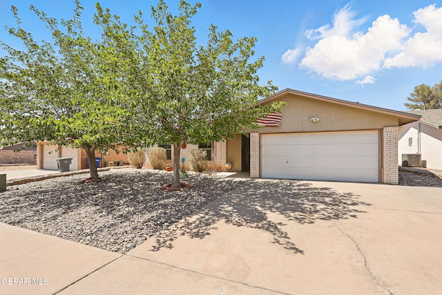 7721 Maya Ave, El Paso, TX 79912 - view of front of house featuring brick siding, driveway, and an attached garage
