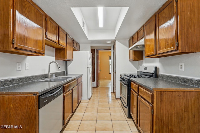 7721 Maya Ave, El Paso, TX 79912 - kitchen featuring appliances with stainless steel finishes, a sink, dark countertops, and under cabinet range hood