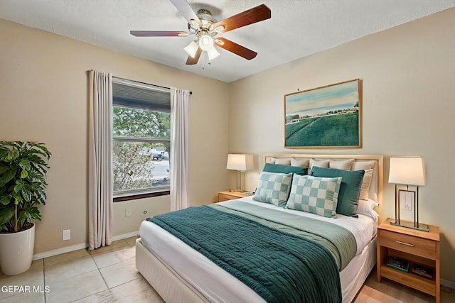 7721 Maya Ave, El Paso, TX 79912 - bedroom with baseboards, a textured ceiling, light tile patterned floors, and ceiling fan
