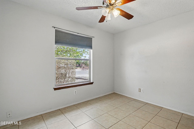 7721 Maya Ave, El Paso, TX 79912 - unfurnished room featuring a textured ceiling, light tile patterned floors, a ceiling fan, and baseboards