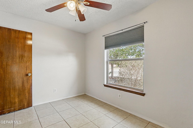 7721 Maya Ave, El Paso, TX 79912 - spare room featuring a textured ceiling, light tile patterned floors, ceiling fan, and baseboards