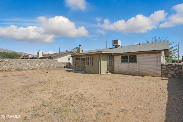 7721 Maya Ave, El Paso, TX 79912 - rear view of property featuring central air condition unit and brick siding