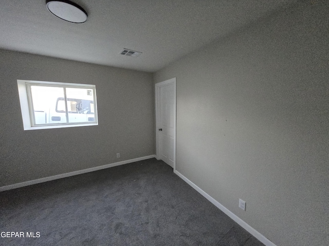 2917 Mobile Ave, El Paso, TX 79930 - unfurnished room with dark carpet and baseboards