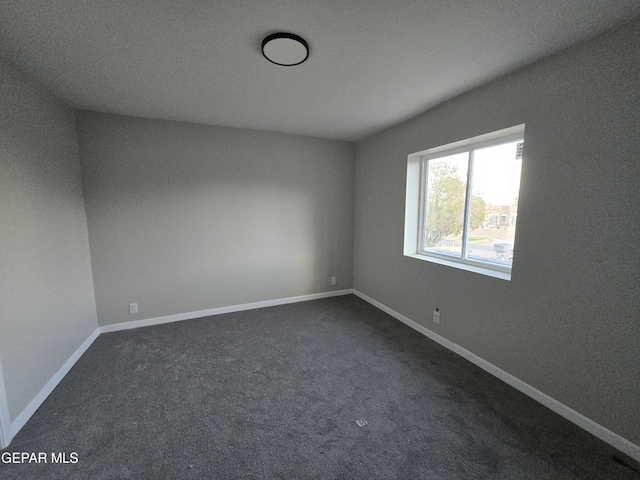 2917 Mobile Ave, El Paso, TX 79930 - unfurnished room with dark colored carpet and baseboards