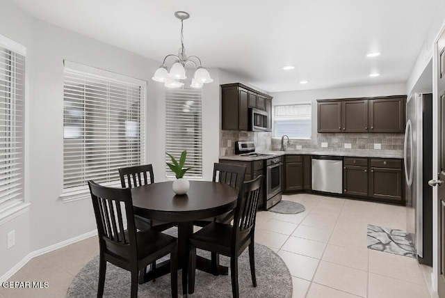 5429 Santiago Roque Dr, El Paso, TX 79934 - dining area featuring light tile patterned flooring, a chandelier, recessed lighting, and baseboards