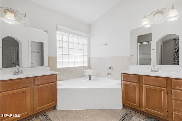 5429 Santiago Roque Dr, El Paso, TX 79934 - full bath with two vanities, a garden tub, tile patterned floors, a shower stall, and vaulted ceiling