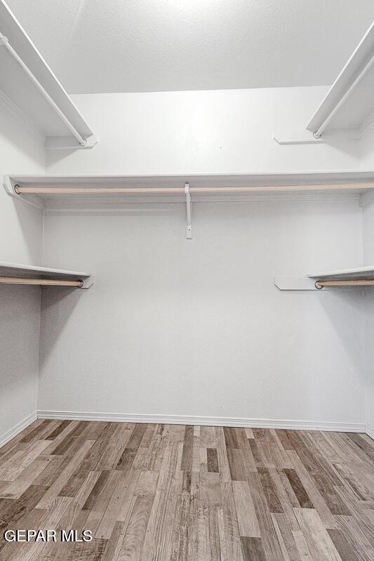 5429 Santiago Roque Dr, El Paso, TX 79934 - spacious closet with wood finished floors