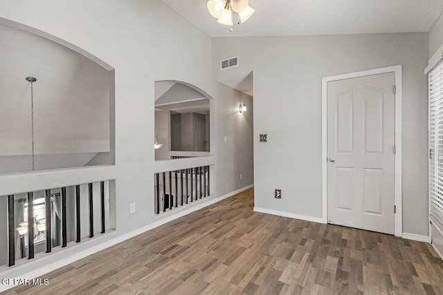 5429 Santiago Roque Dr, El Paso, TX 79934 - empty room with wood finished floors, a ceiling fan, baseboards, and high vaulted ceiling