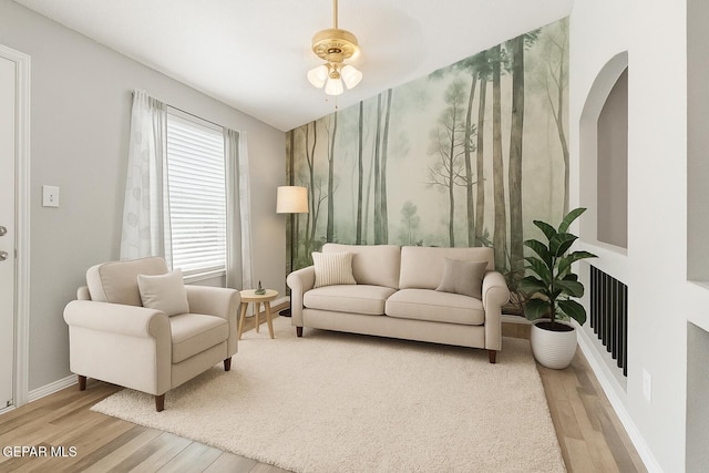 5429 Santiago Roque Dr, El Paso, TX 79934 - living room featuring wood finished floors, a ceiling fan, baseboards, and arched walkways