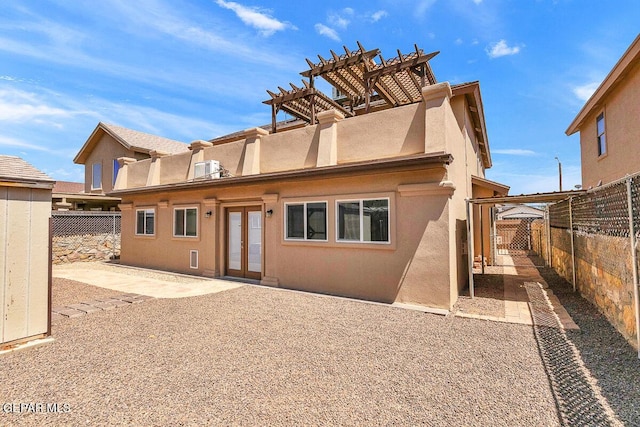 5429 Santiago Roque Dr, El Paso, TX 79934 - rear view of property featuring french doors, stucco siding, a pergola, and a fenced backyard