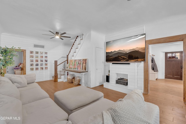 305 N Carolina Dr, El Paso, TX 79915 - living room with a ceiling fan, stairs, wood finished floors, and a fireplace with raised hearth