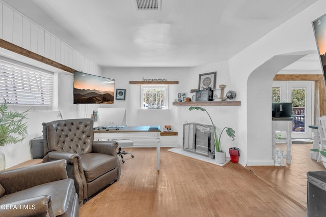 305 N Carolina Dr, El Paso, TX 79915 - living area with wood finished floors, arched walkways, a fireplace, and baseboards