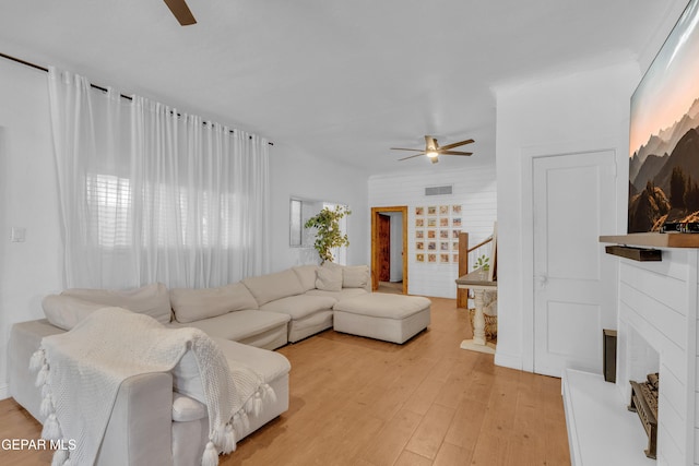 305 N Carolina Dr, El Paso, TX 79915 - living room with ceiling fan, a fireplace with raised hearth, and light wood finished floors
