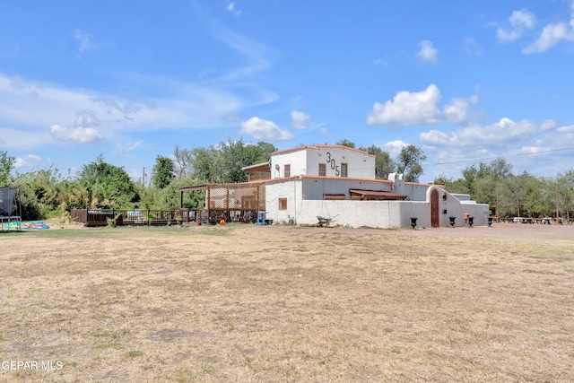 305 N Carolina Dr, El Paso, TX 79915 - rear view of property featuring a trampoline and a yard