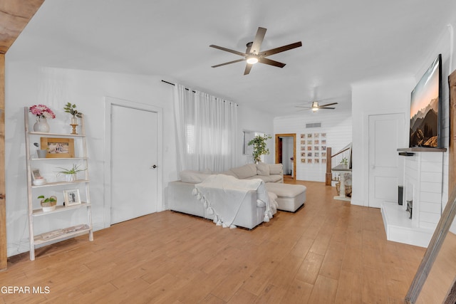 305 N Carolina Dr, El Paso, TX 79915 - living area featuring ceiling fan, a fireplace, and light wood-style floors
