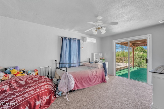 305 N Carolina Dr, El Paso, TX 79915 - bedroom featuring access to exterior, a textured ceiling, a wall unit AC, carpet flooring, and a ceiling fan