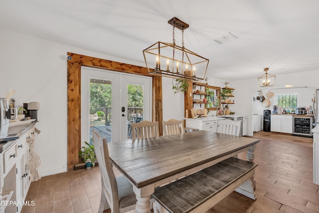 305 N Carolina Dr, El Paso, TX 79915 - dining space with a chandelier, light wood-type flooring, wine cooler, and french doors
