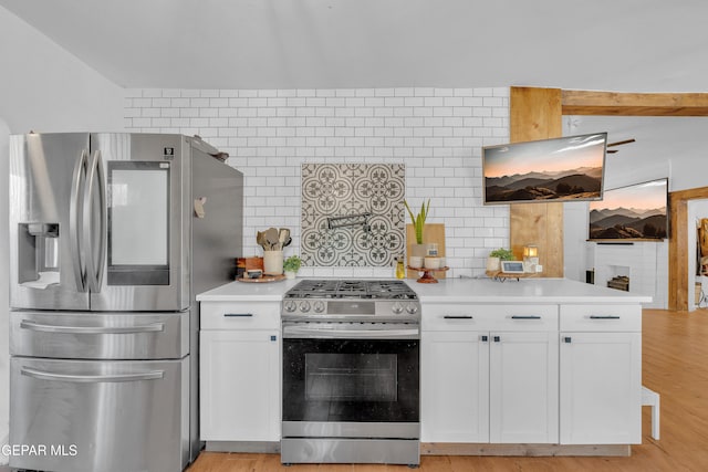 305 N Carolina Dr, El Paso, TX 79915 - kitchen with appliances with stainless steel finishes, white cabinetry, decorative backsplash, and light countertops