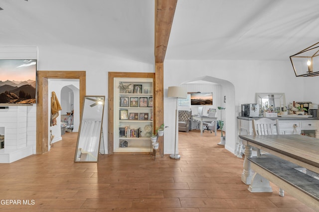 305 N Carolina Dr, El Paso, TX 79915 - hall with arched walkways, wood finished floors, and built in shelves