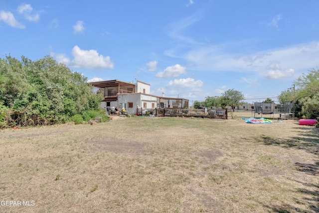 305 N Carolina Dr, El Paso, TX 79915 - view of grassy yard with a trampoline and a deck