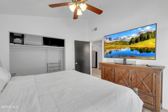 305 N Carolina Dr, El Paso, TX 79915 - bedroom with a closet, freestanding refrigerator, high vaulted ceiling, ceiling fan, and tile patterned flooring