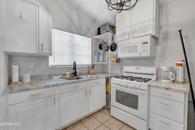305 N Carolina Dr, El Paso, TX 79915 - kitchen featuring white appliances, a sink, white cabinets, and light countertops