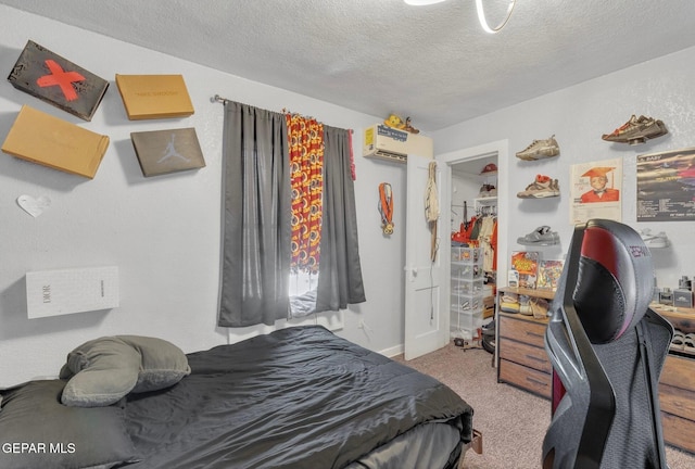 305 N Carolina Dr, El Paso, TX 79915 - carpeted bedroom featuring a textured ceiling, an office area, and a wall mounted AC