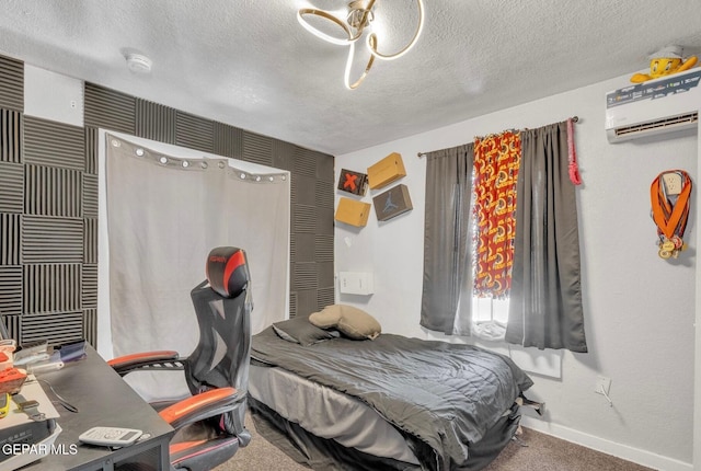 305 N Carolina Dr, El Paso, TX 79915 - carpeted bedroom featuring a textured ceiling, a desk, an AC wall unit, and baseboards