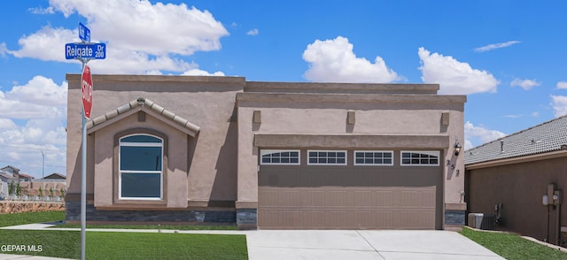 1329 Madero Ave, El Paso, TX 79928 - view of front facade with concrete driveway, central air condition unit, stucco siding, and a front yard