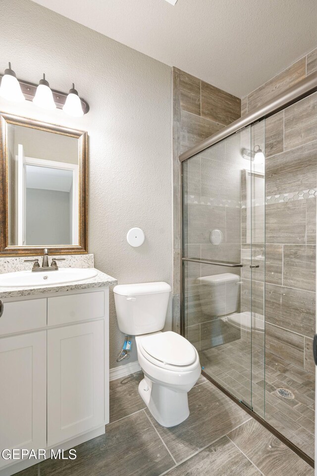 1329 Madero Ave, El Paso, TX 79928 - full bathroom featuring toilet, vanity, and a stall shower