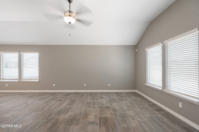 1329 Madero Ave, El Paso, TX 79928 - spare room featuring vaulted ceiling, a ceiling fan, healthy amount of natural light, dark wood-type flooring, and baseboards