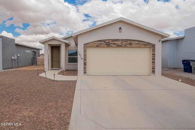 1916 William Caples St, El Paso, TX 79938 - view of front facade featuring stucco siding, concrete driveway, a garage, and stone siding
