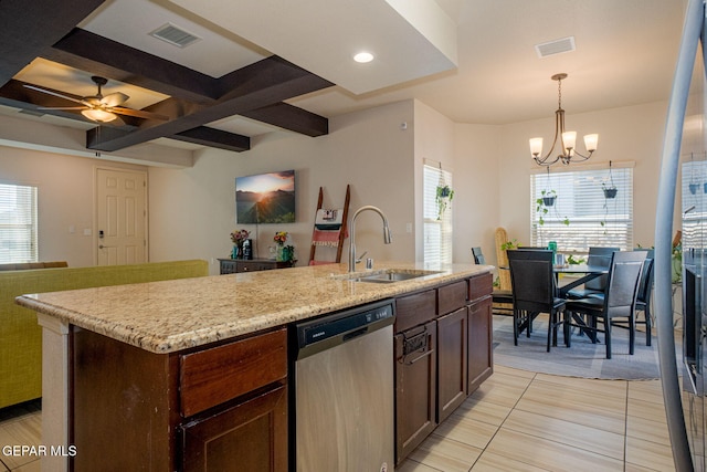 1916 William Caples St, El Paso, TX 79938 - kitchen with stainless steel dishwasher, a sink, open floor plan, light tile patterned flooring, and a chandelier